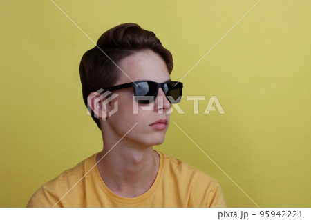 Portrait of a cute teen boy with glasses. 95942221