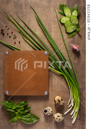 Quail eggs and green onion chives at table background. Cooking concept and salad ingredients Quail eggs and green onion chives at table background. Cooking concept and salad ingredients 95943358