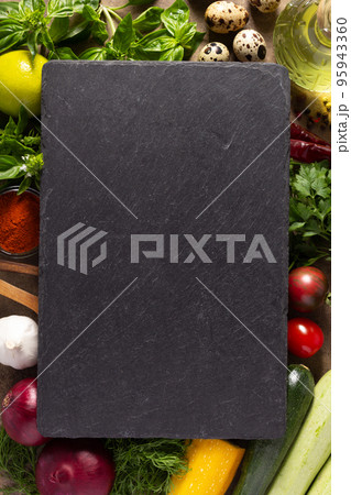 Variety of fresh vegetables slate stone at table background. Cooking concept and salad ingredients 95943360