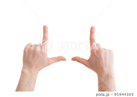 A person chooses a frame for a photo. Hands show the boundary of the frame. 95944303