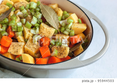 Slices of vegetables prepared for cooking in the oven Slices of vegetables prepared for cooking in the oven 95944503