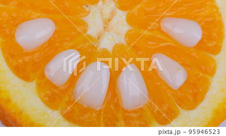 Close-up super thin porcelain laminated white veneers lying down on a piece of orange. Close-up super thin porcelain laminated white veneers lying down on a piece of orange. 95946523