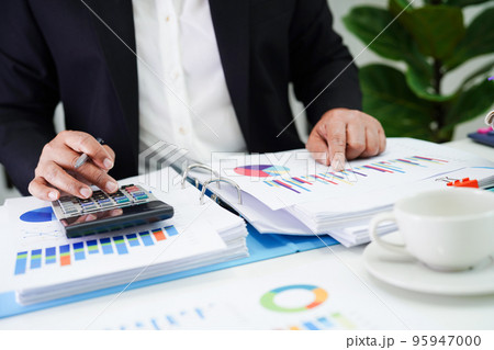 Business woman working and analysis with statistic graph in office. Business woman working and analysis with statistic graph in office. 95947000