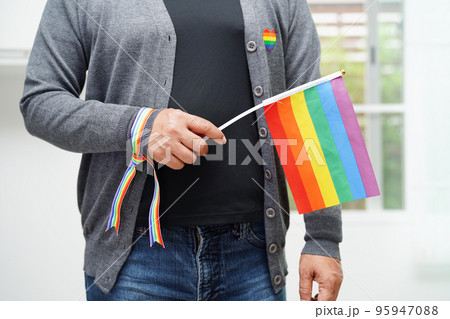 Asian woman with rainbow flag, LGBT symbol rights and gender equality, LGBT Pride Month in June. 95947088