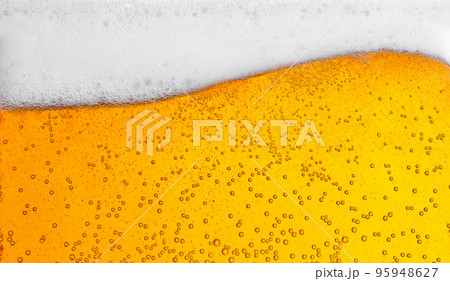 pouring beer with bubbles for background and wave shape texture foam 95948627