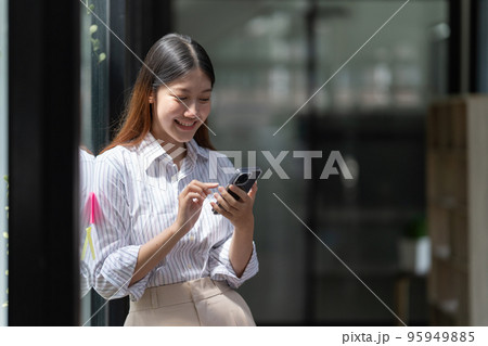 A businesswoman completes KYC using an online banking program in order to open a digital savings account. The definition of cyber security 95949885