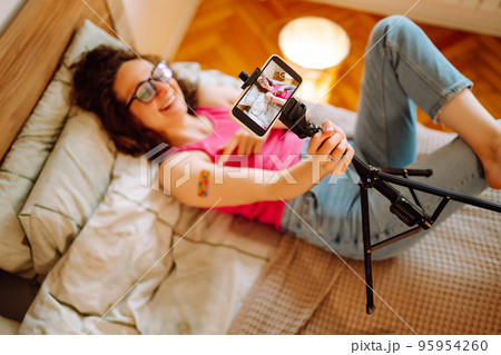 Woman blogger videotapes her vlog at home and speaking about Vaccine for covid-19. Woman blogger videotapes her vlog at home and speaking about Vaccine for covid-19. 95954260