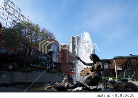 SAN FRANCISCO, CALIFORNIA, UNITED STATES - NOV 25th, 2018: Visitors in Ghirardelli Square with fountain. It's a famous landmark public square with shops and restaurants of San Francisco SAN FRANCISCO, CALIFORNIA, UNITED STATES - NOV 25th, 2018: Visitors in Ghirardelli Square with fountain. It's a famous landmark public square with shops and restaurants of San Francisco 95955626