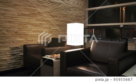 CHICAGO, ILLINOIS, UNITED STATES - DECEMBER 16, 2015: Seating area with leather recliner in airport lounge for frequent flyers at Chicago O'Hare International Airport CHICAGO, ILLINOIS, UNITED STATES - DECEMBER 16, 2015: Seating area with leather recliner in airport lounge for frequent flyers at Chicago O'Hare International Airport 95955667