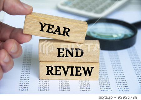 Year end review text on wooden blocks. Year end review and business concept. Year end review text on wooden blocks. Year end review and business concept. 95955738