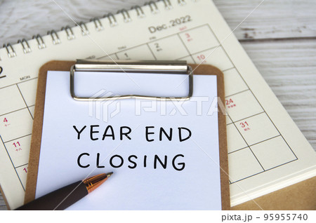 Year end closing text on white notepad with December calendar background. business closing concept. 95955740