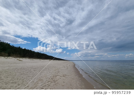A picturesque view of the coastline of the sea. Sandy beach. A picturesque view of the coastline of the sea. Sandy beach. 95957239