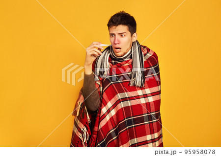 Picture from a young man with handkerchief. I am sick. plaid wrapped himself. studio shot. 95958078