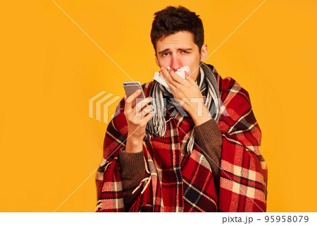 Picture from a young man with handkerchief. I am sick. plaid wrapped himself. studio shot. Picture from a young man with handkerchief. I am sick. plaid wrapped himself. studio shot. 95958079