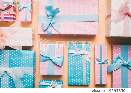 A lot of Christmas gift boxes in colored paper decorated on table, Top view close up. Many present New Year gift 95958504