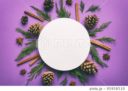Flat lay Christmas composition. Round Paper blank, pine tree branches, christmas decorations on Colored background. Top view, copy space for text Flat lay Christmas composition. Round Paper blank, pine tree branches, christmas decorations on Colored background. Top view, copy space for text 95958510