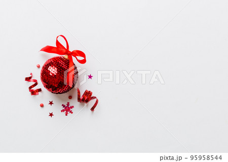 Christmas ball on colored background. decoration bauble with ribbon bow with copy space Christmas ball on colored background. decoration bauble with ribbon bow with copy space 95958544