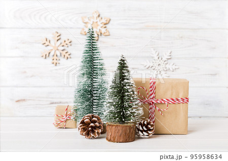 Christmas composition. Gifts, small tree, branches and craft DIY decorations on white background. New year concept. Christmas home decoration Flat lay, top view, copy space Christmas composition. Gifts, small tree, branches and craft DIY decorations on white background. New year concept. Christmas home decoration Flat lay, top view, copy space 95958634