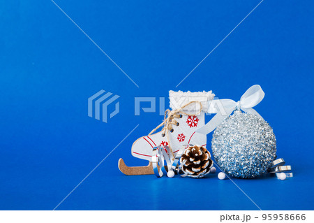 Christmas ball with skates on colored background. decoration bauble with ribbon bow with copy space Christmas ball with skates on colored background. decoration bauble with ribbon bow with copy space 95958666