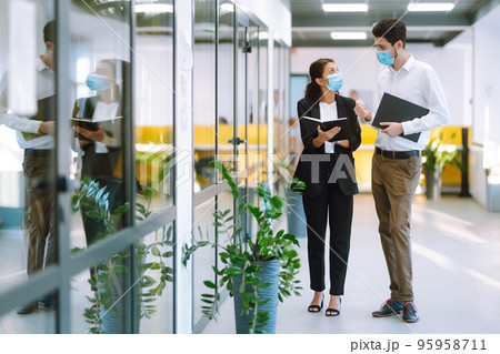 Two manager in protective face masks having an argument discussing business Issue. Covid-19. 95958711