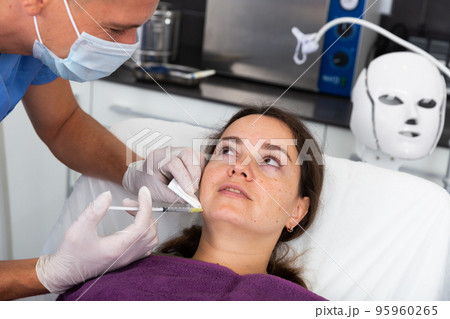Woman getting cosmetic facial injection in clinic Woman getting cosmetic facial injection in clinic 95960265