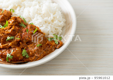 chicken tikka masala with rice on plate 95961012
