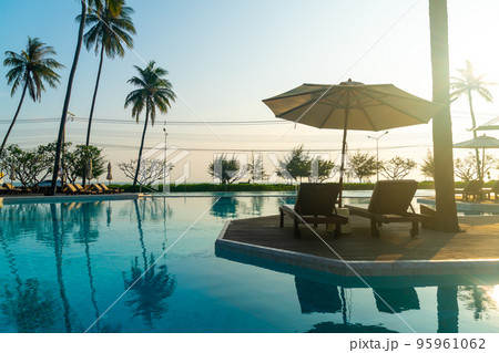 umbrella with bed pool around swimming pool with ocean sea background 95961062