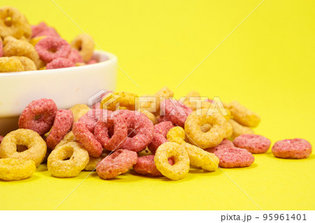 Quick cereal breakfast in the form of rings on a plate on a yellow background Quick cereal breakfast in the form of rings on a plate on a yellow background 95961401