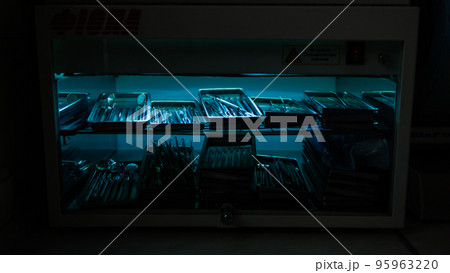 Dental instruments are sterilized in a autoclave under an ultraviolet lamp 95963220