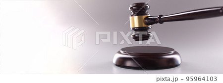 Wooden judges gavel on soundboard on grey background Wooden judges gavel on soundboard on grey background 95964103