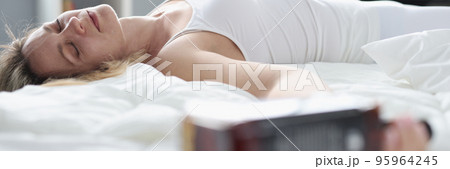 Drunk woman sleeping in bed and holding bottle of whisky Drunk woman sleeping in bed and holding bottle of whisky 95964245