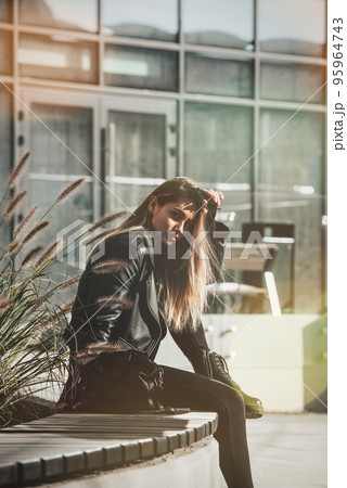 Urban woman sitting on a bench of a park and breathing deep fresh air 95964743