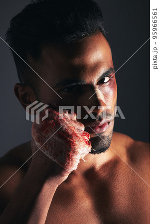 Violence, man and portrait with blood fist of angry fighter with bruise, injury and wound plaster. Boxer, fitness and anger aggression of mma person with intense dark studio shadow background. Violence, man and portrait with blood fist of angry fighter with bruise, injury and wound plaster. Boxer, fitness and anger aggression of mma person with intense dark studio shadow background. 95966561