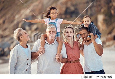 Family beach portrait, child on shoulder and dad, mom and multicultural grandparents together on vacation. Happy big family, generation smile with happiness outdoor in summer holiday for diversity Family beach portrait, child on shoulder and dad, mom and multicultural grandparents together on vacation. Happy big family, generation smile with happiness outdoor in summer holiday for diversity 95966760