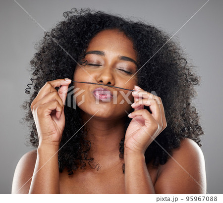 Face, beauty and hair care of black woman with eyes closed on gray studio background. Wellness, skincare and female model from Nigeria with healthy and long curly hair after luxury salon treatment Face, beauty and hair care of black woman with eyes closed on gray studio background. Wellness, skincare and female model from Nigeria with healthy and long curly hair after luxury salon treatment 95967088