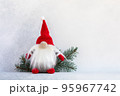 Christmas gnome in red cap with fir branch holiday card on light winter background 95967742