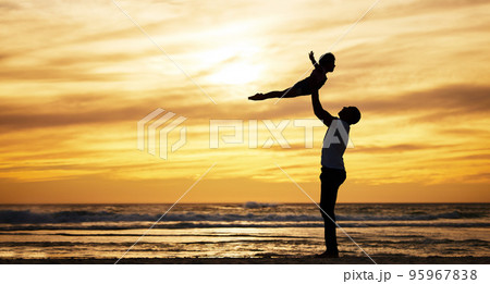 Family, silhouette and sunset by beach with dad lifting child in air to fly while on vacation in summer with love, care and support outdoor. Man and kid playing airplane while on holiday by sea Family, silhouette and sunset by beach with dad lifting child in air to fly while on vacation in summer with love, care and support outdoor. Man and kid playing airplane while on holiday by sea 95967838