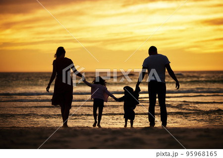 Family, holding hands and silhouette at the beach at sunset, adventure and love with parents and children outdoor. Mother, father and kids together, trust and freedom by the ocean, nature and care. 95968165