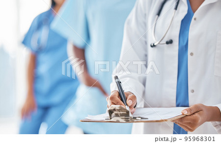 Hands, documents and doctor writing at hospital for compliance, information and insurance. Hand, paper and healthcare woman filling form, clipboard and prescription while planning appointment 95968301