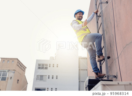 Engineer, ladder and thumbs up with man climbing on a building during construction inspection. Agree, approve and thumbsup with builder working on building architecture for maintenance and repair 95968314
