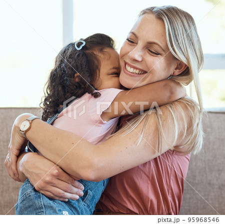 Mother, hug and child love on a home living room sofa feeling interracial family and kid care. Mama, happy girl and parent loving her kid with a smile on a house lounge couch hugging in a family home Mother, hug and child love on a home living room sofa feeling interracial family and kid care. Mama, happy girl and parent loving her kid with a smile on a house lounge couch hugging in a family home 95968546