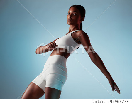Fitness, body and stretching woman in studio portrait with workout clothes on blue mock up for marketing or advertising space. Young black woman or fashion model dancing and training with mockup 95968773