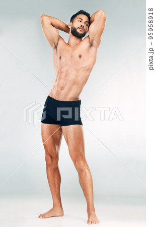 Muscle, strong and body of a man for fitness, health and motivation for goal against grey mockup studio background. Thinking, sports and bodybuilder model with sexy, young and healthy abs from sports Muscle, strong and body of a man for fitness, health and motivation for goal against grey mockup studio background. Thinking, sports and bodybuilder model with sexy, young and healthy abs from sports 95968918