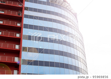Multi storey glass building in sunlight closeup 95969856