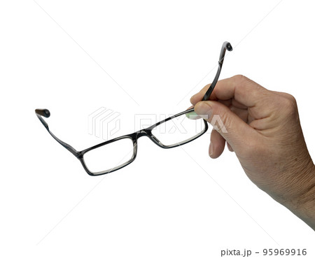 a pair of eyeglasses in a man's hand a pair of eyeglasses in a man's hand 95969916