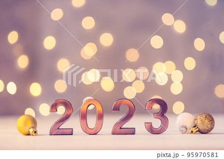 Metal numbers 2023 on a white table with bokeh lights. Happy New Year 2022 is coming concept. 95970581
