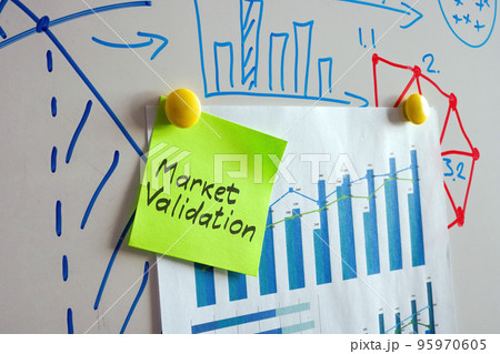 Whiteboard with charts and sticker market validation. 95970605