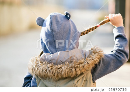 Portrait of happy child girl with hair braids in warm clothes in autumn outdoors. Portrait of happy child girl with hair braids in warm clothes in autumn outdoors. 95970736