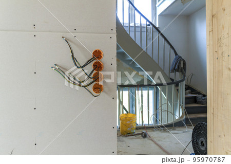 New electrical installation, socket plastic boxes and electrical cables on the wall, renovation concept. Electrical wiring installation. 95970787