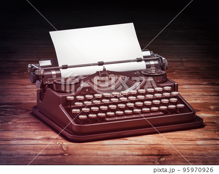 Vintage typewriter with blank sheet on wooden table. 95970926